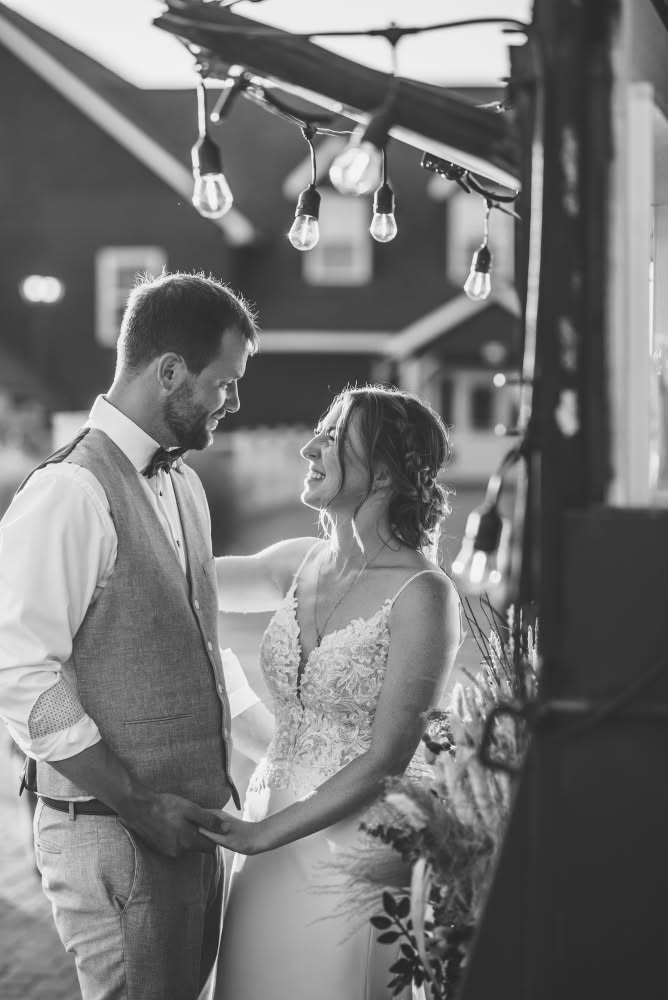 Newlyweds holding hands beside the Dark Horse Tavern trailer